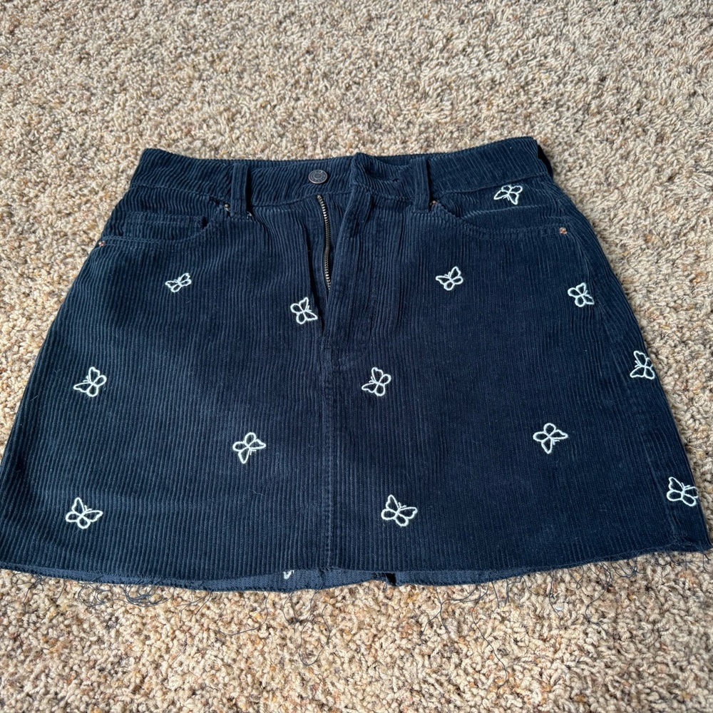 Women’s corduroy navy blue mini skirt from PacSun with butterfly detail